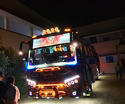 Brightly illuminated travel bus at night